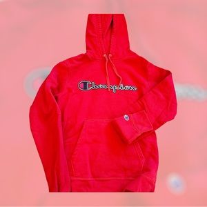 Red hooded, champion hoodie with pockets.